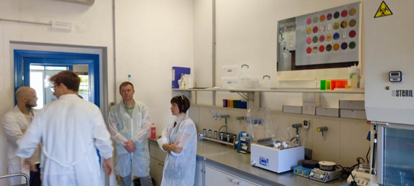 Four persons in a lab.